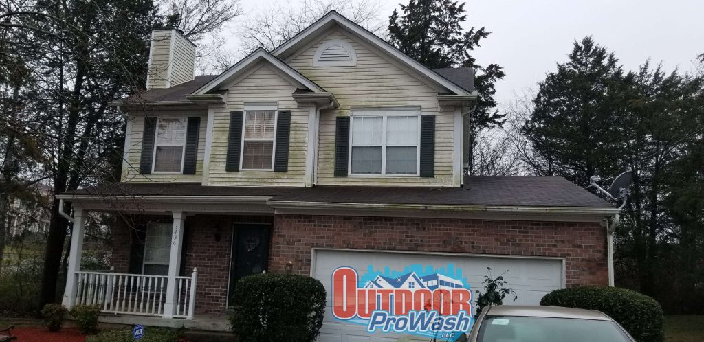 A house with a car parked in front of it.