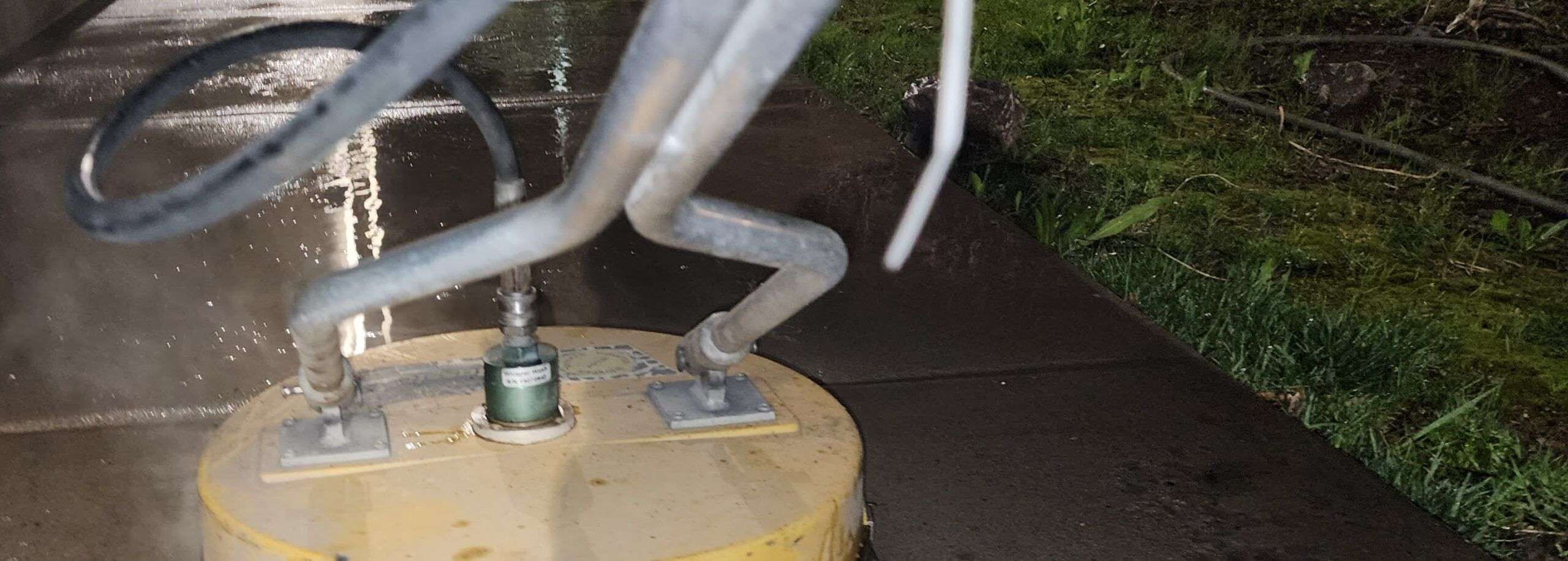 A close up of the water tank with a hose attached to it